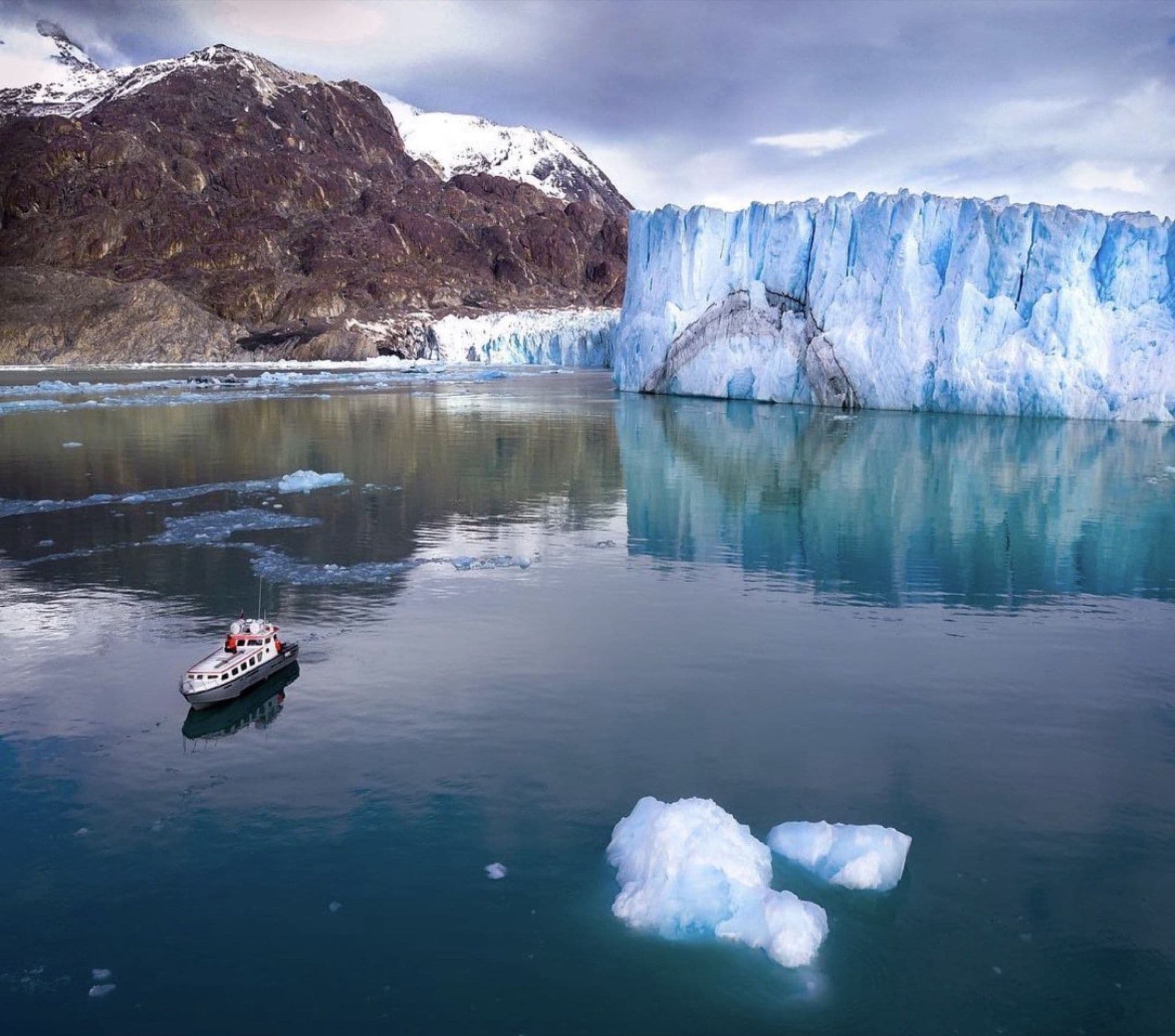 The wall of the Great O'Higgins Glacier, with one of our boats sailing in front of the ice