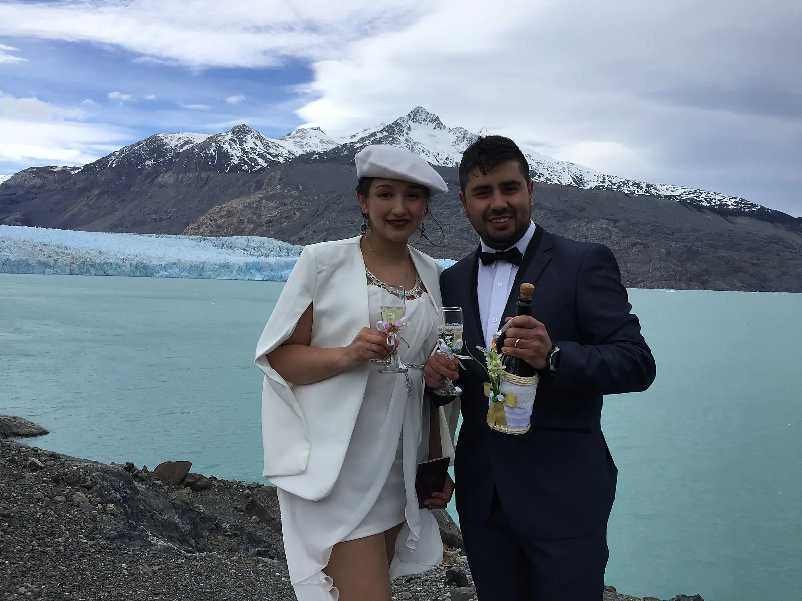 Mariana and Jonathan toasting in front of the O'Higgins Glacier on their wedding day