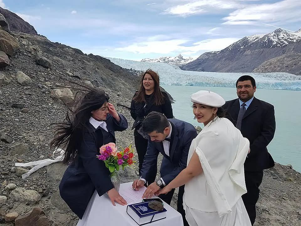 Mariana and Jonathan signing the marriage certificate, with the O'Higgins Glacier as witness